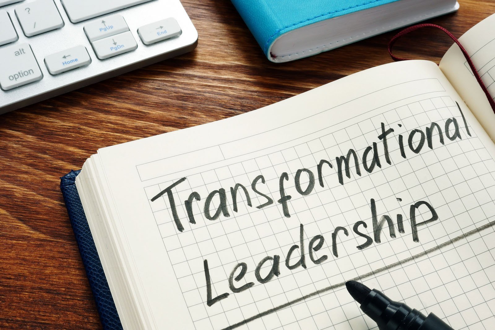 Transformational leadership handwritten in a note pad.